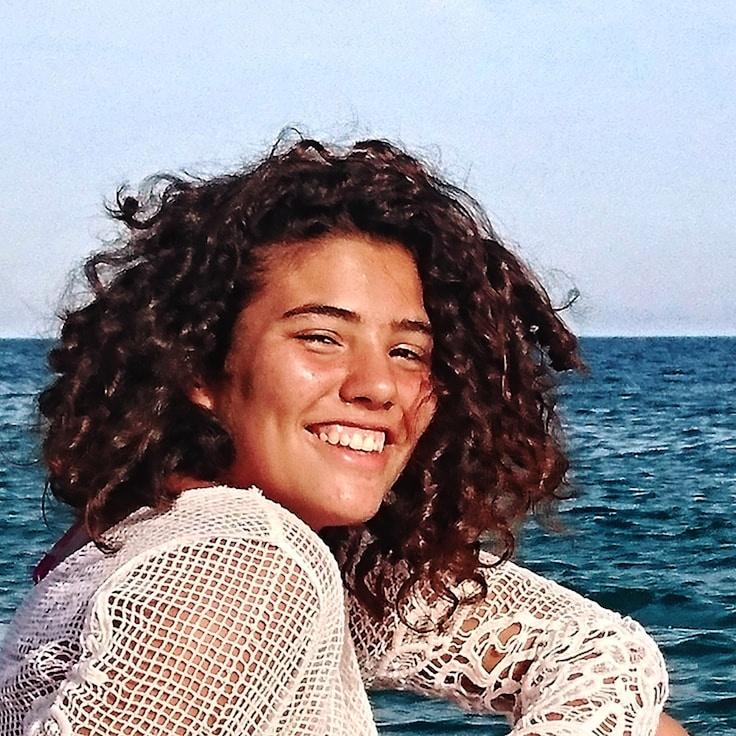 Anya Gupta, Lead Design Curator at Nova Crate Gentle, reviewing corporate floral arrangements